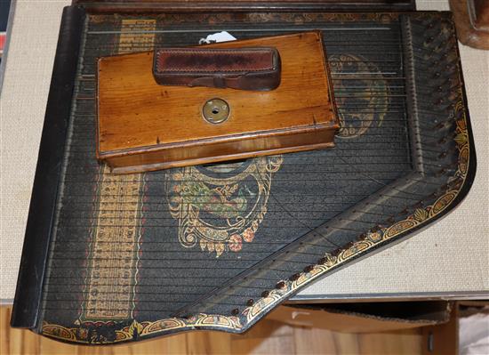 A leather cased portable surveying instrument, an oak cased set of balance scales and a zither